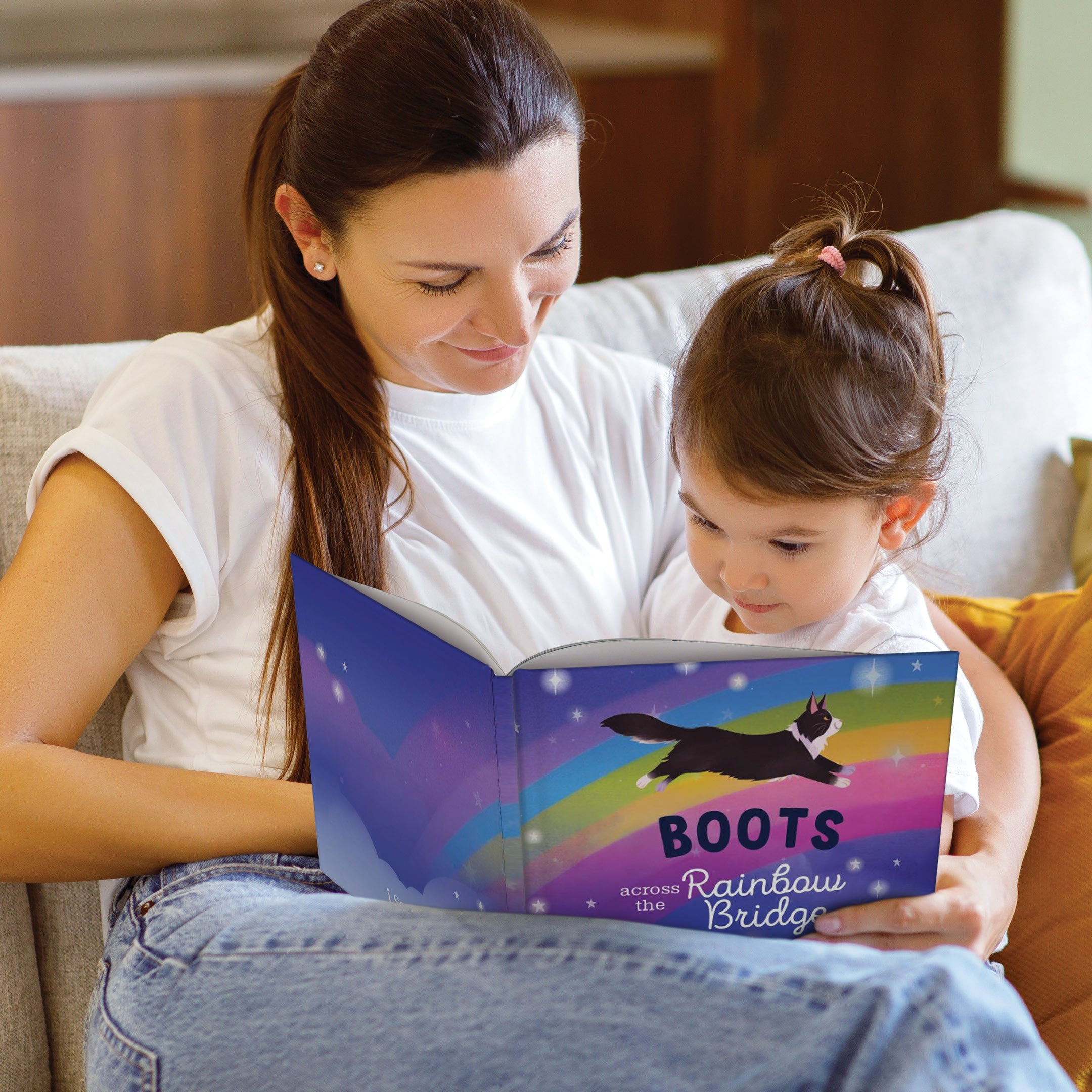 Woman and child reading a book together on a couch