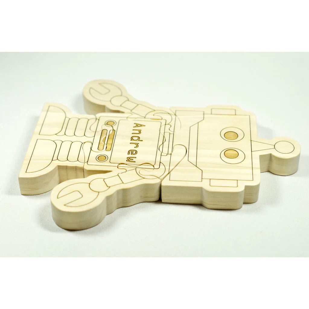 Wooden robot puzzle with 'Andrew' engraved on a white background
