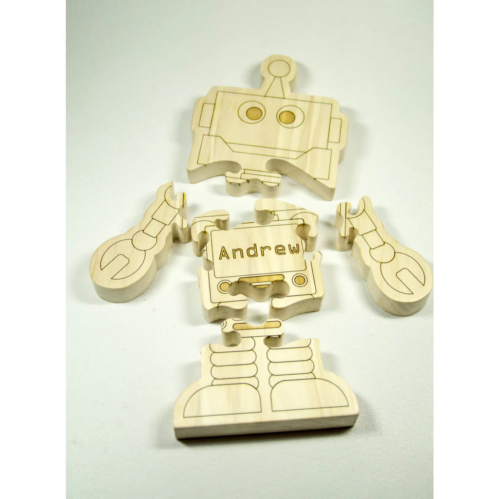 Wooden robot puzzle with 'Andrew' engraved on a light gray background
