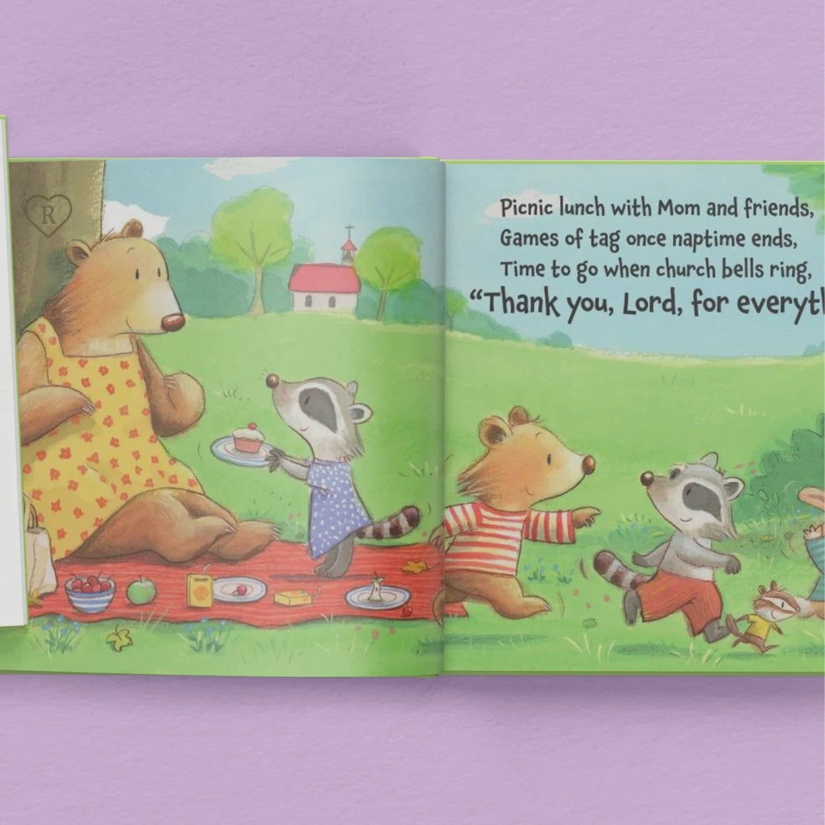 Illustrated book open to a page with animals at a picnic on a purple background